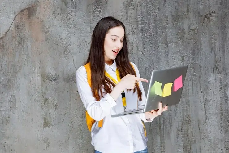 girl holding a laptop with stickers